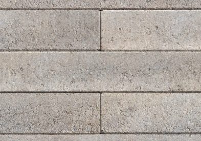Segmental retaining wall system with a linear, modern aesthetic.
